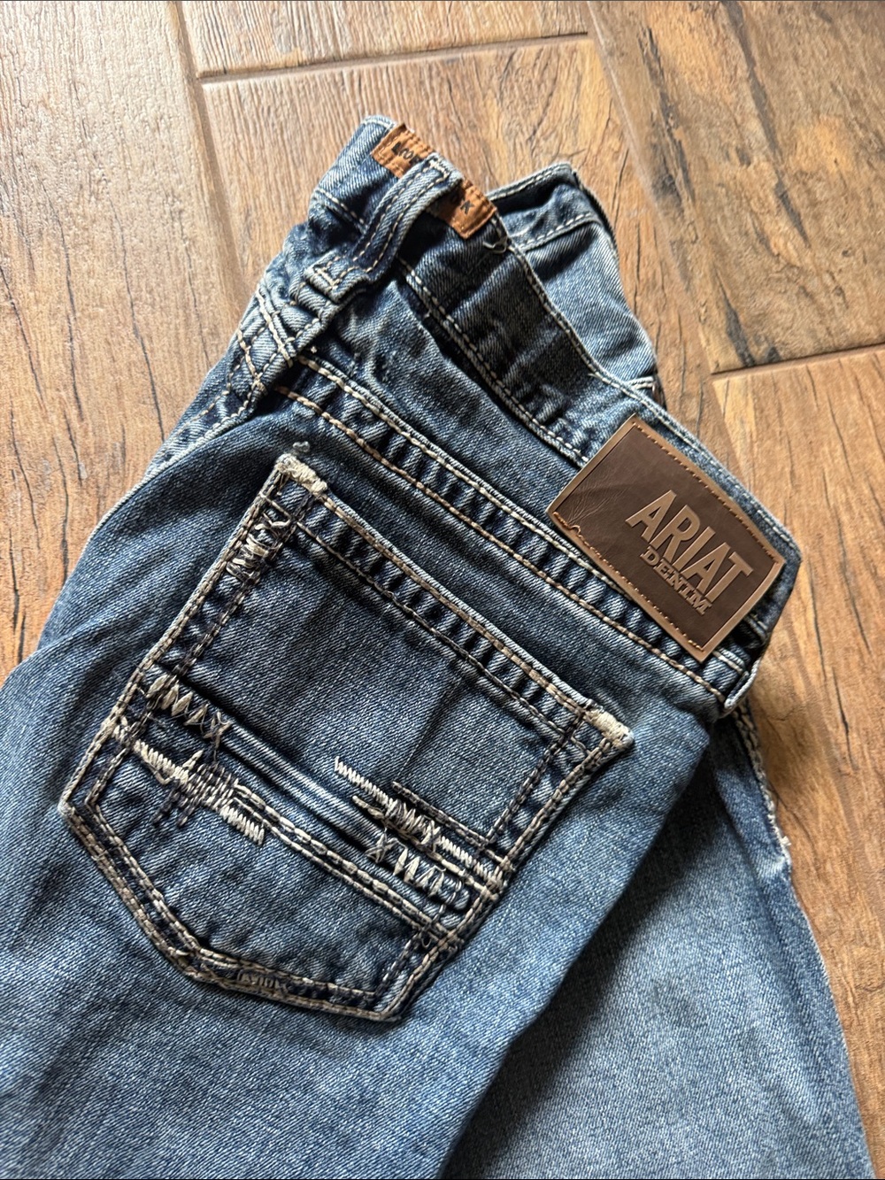 Ariat Men's Medium Blue Straight Leg Jeans with Contrast Stitching.
